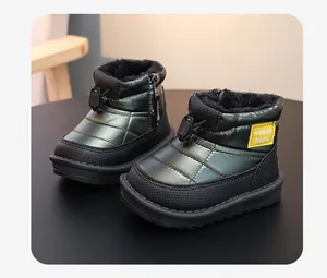 Detail showing dark green waterproof quilted children's snow boots with plush lining.