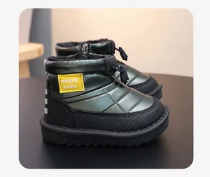 Close-up detail of waterproof green children snow boots with warm faux fur lining