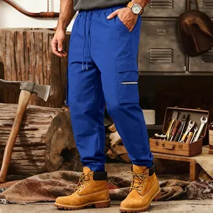 Men's loose blue cargo sweatpants with multi-pockets and drawstring waist in a workshop set.