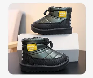 Detail view of waterproof children's snow boots with metallic green finish and warm lining