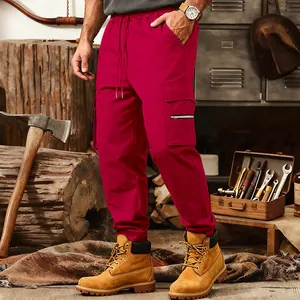 Close-up of red tactical cargo sweatpants featuring multiple utility pockets and drawstring