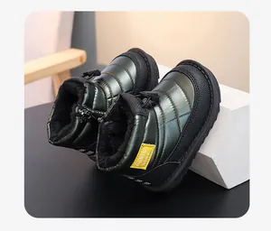 Detailed view of kids' waterproof snow boots with warm black faux fur lining