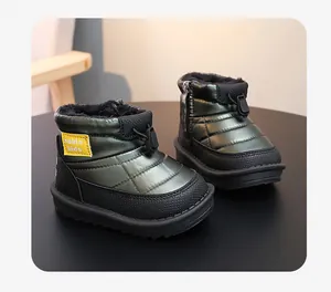 Close-up view of waterproof kids snow boots featuring a warm black fleece lining