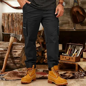 Detail of men's black multi-pocket tactical cargo pants in a rugged workshop setting