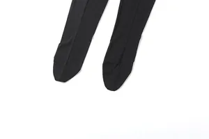 Close-up of black sheer mesh fabric on the footed part of a sexy bodysuit
