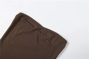 Close-up detail of the fine stitching and brown fabric texture of a bodycon jumpsuit
