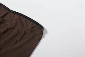 Close-up detail of the anti-slip silicone strip on a brown mesh strapless jumpsuit bodice.