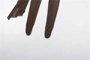 Detail view of brown sheer mesh footed jumpsuit with stretchy fabric texture.