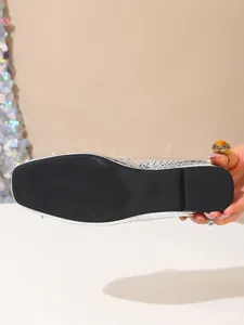 Close-up view of the black non-slip sole on a silver ballet flat shoe with size 37 stamp