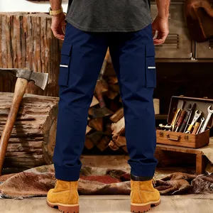 Detailed back view of men's navy blue tactical cargo sweatpants in a workshop setting