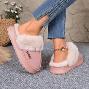 Stylish pink winter fuzzy slippers with thick faux fur trim worn with blue denim jeans