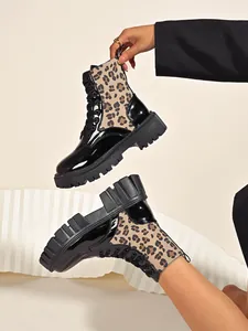 Detailed view of leopard print combat boots featuring chunky platform soles and laces