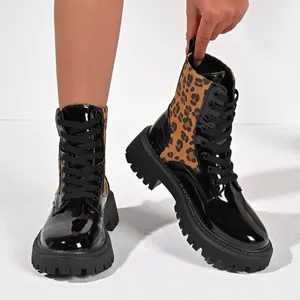 Detail of leopard print platform Martin boots with shiny black finish and chunky sole