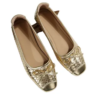 Elegant French style gold ballet flats featuring a woven texture and bow detail on the toe