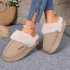 Close-up detail of beige winter house slippers with thick faux fur trim and SPORT embroidery