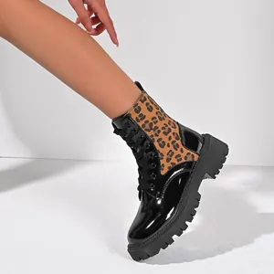 Close-up of women's leopard print chunky heel combat boots in black patent leather