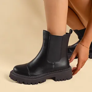 Detailed view of women's black Chelsea boots featuring a chunky platform lug sole and round toe