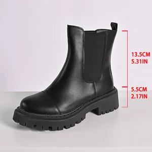 Detail view of black chunky Chelsea boots with heel and shaft height measurements in cm