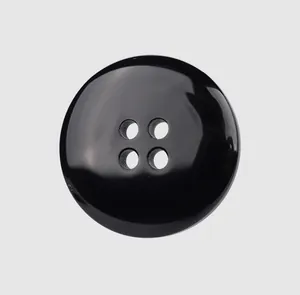 Macro detail of high-gloss black resin 4-hole button suitable for luxury garments