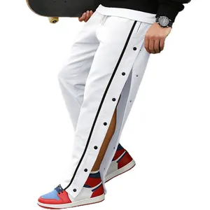White tear-away track pants for men with side snap buttons and black stripe