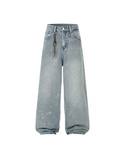 Vintage blue wide-leg jeans featuring white paint splatter and rhinestone accents