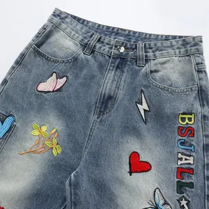 Trendy loose straight denim pants with colorful embroidery patches and BSJALL text