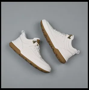 Top-down view of premium white leather mid-top sneakers with durable gum soles.
