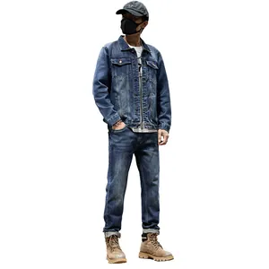 Classic men's blue denim outfit including a washed jacket and matching straight jeans.