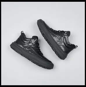 Detail view of premium black genuine leather men's sneakers with stylish lace-up design