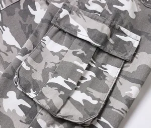 Close-up of a large cargo pocket on grey camouflage cargo pants showing detailed stitching.