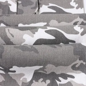 Close-up of gray and white camouflage pattern on durable twill cargo pants fabric.