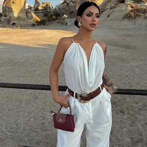 Detail view of a sexy white halter tank top with elegant metal neck ring and cowl neck