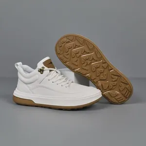 Premium white cowhide leather men's casual sneakers with durable brown traction sole