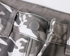 Detail shot of camouflage cargo pants waist with metal button and zipper closure