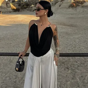 Detail of black sexy backless top with chic gold metal halter neck design