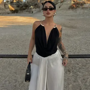 Elegant black backless drape neck top featuring a stylish gold metal halter collar detail