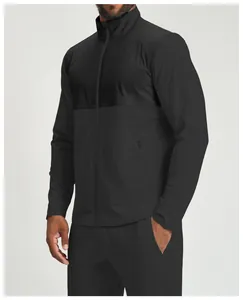 Close-up view of men's black color-block athletic jacket with textured fabric panels.