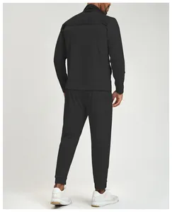 Detailed rear view of men's black athletic tracksuit featuring textured color-block paneling