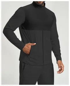 Detail view of men's black athletic zip-up jacket featuring textured patchwork.