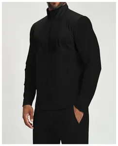 Detail view of men's black athletic zip-up jacket with mixed fabric panels