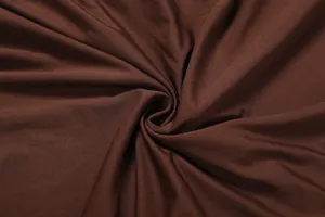 Close-up of the soft chocolate brown fabric texture showing elegant drapes and fine knit detail
