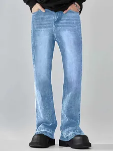 Detail of men's American style light blue flare jeans with whiskering effects.