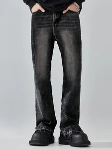 Full view of men's loose straight leg jeans featuring vintage cat whisker fading effect