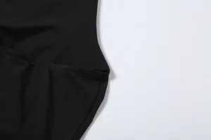 Close-up detail of the fine stitching and smooth fabric texture on the black halter top
