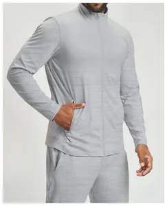 Detail of men's athletic jacket showing the grey color-block design and fabric texture
