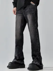Detail of men's charcoal flare jeans featuring whiskers and a functional side zipper hem