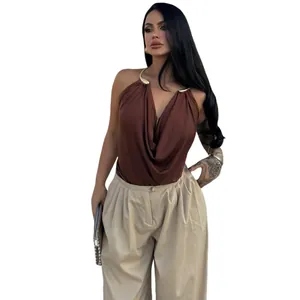 Detailed view of women's brown cowl neck halter top with gold metal hardware
