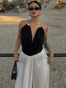Elegant black cowl neck halter top with metallic gold collar detail and open back