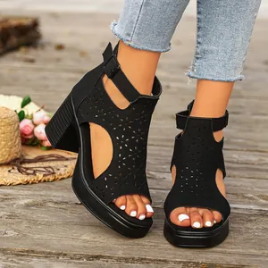 Black chunky heel sandals featuring laser-cut floral patterns and comfortable platform.