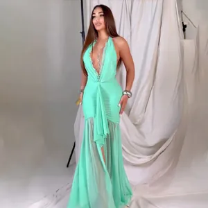 Mint green halter neck maxi dress with elegant ruched bodice and sheer mesh panels